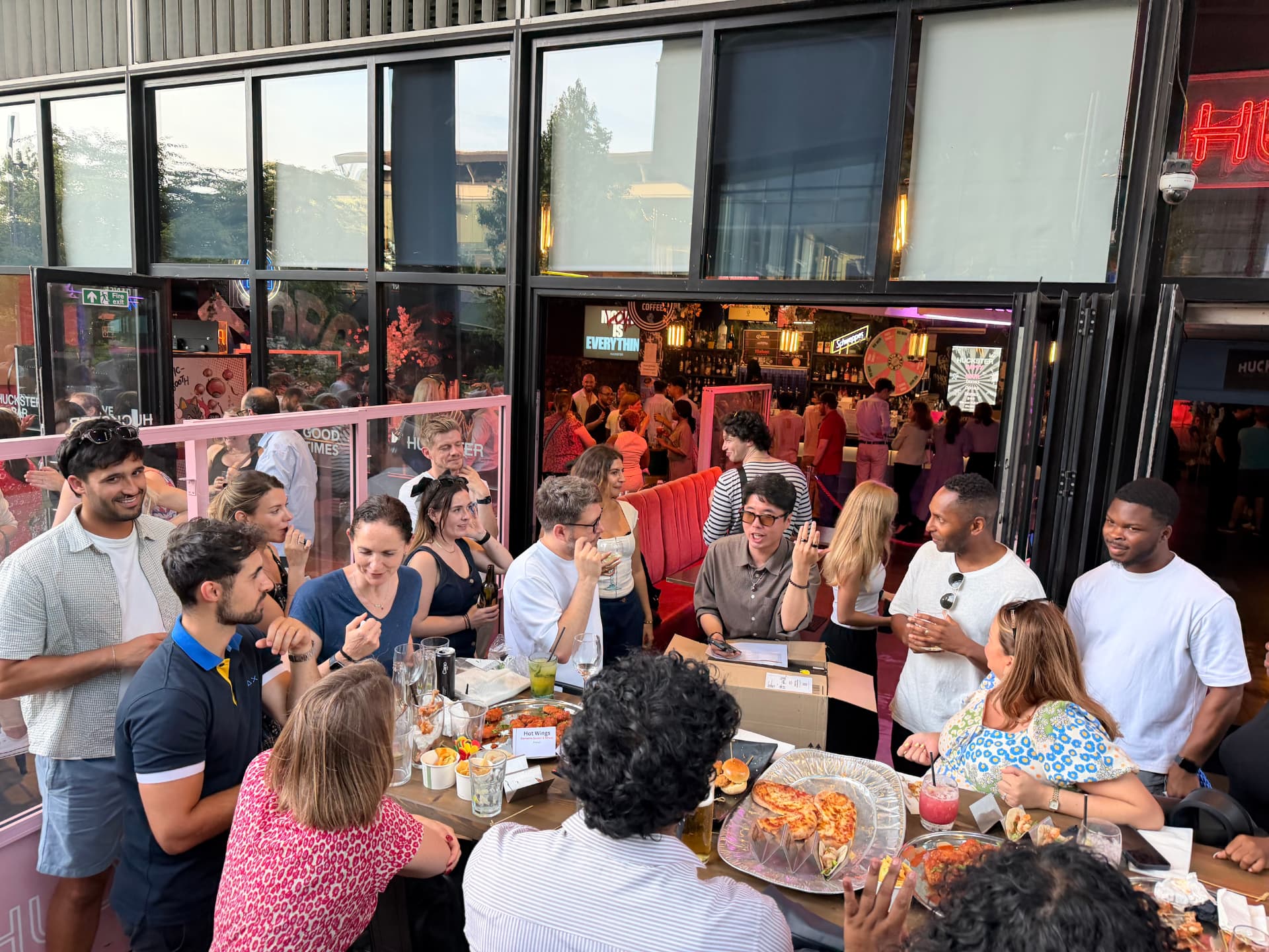 YOOBIC London teammates at the summer party on a terrace with long tables of food