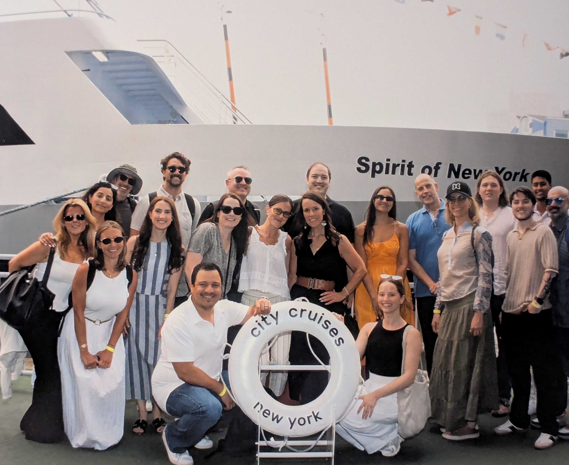 YOOBIC New York teammates posing on a dock around a life ring before a boat cruise