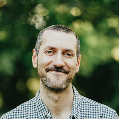 Vital Isaac, Product and Engineering at YOOBIC, smiling outdoors